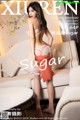 A woman in lingerie standing on a white couch.